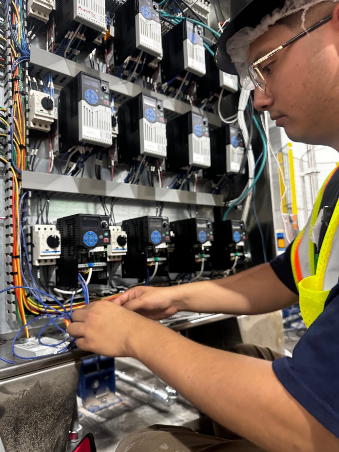 SIE electrician wiring variable frequency drives in a control panel