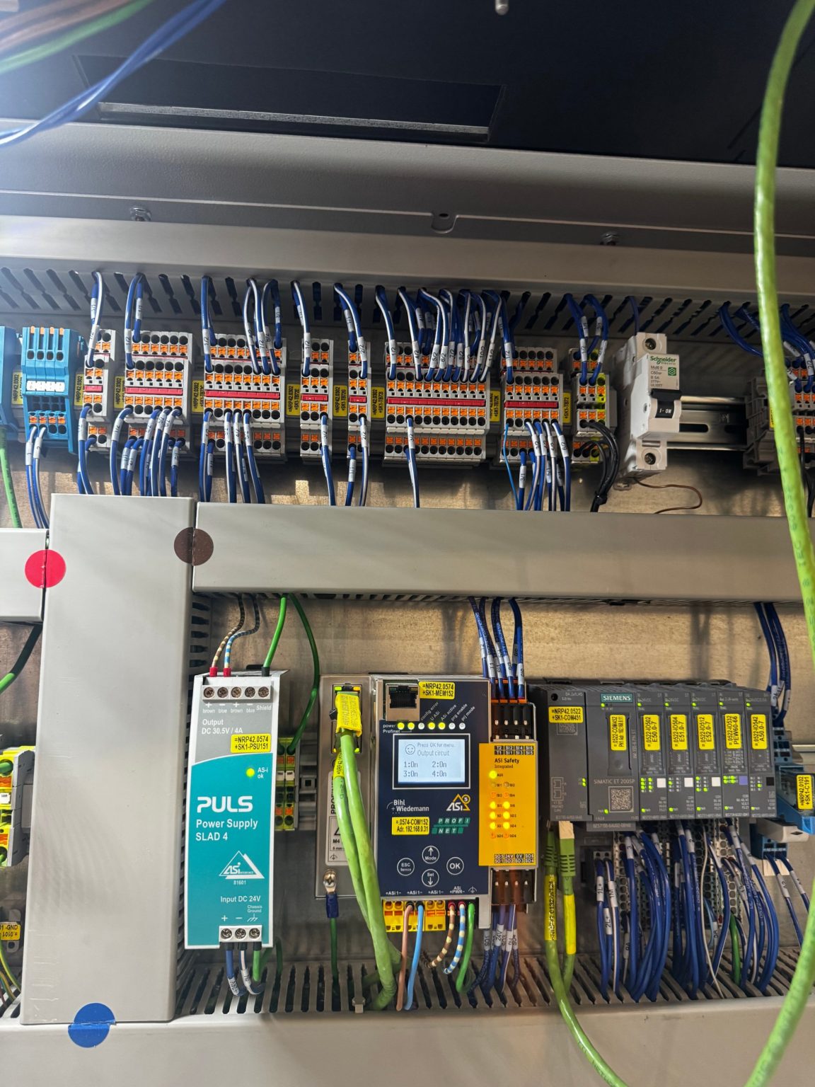 Control cabinet with labeled terminal blocks, power supply and remote I/O