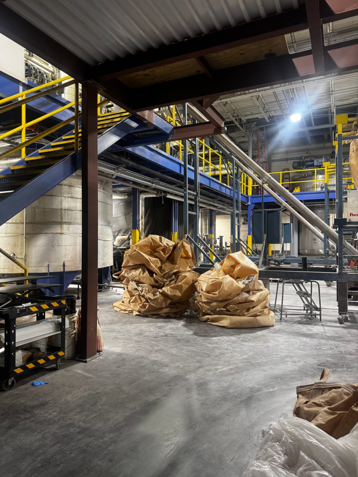 Chemical plant process area with tanks and mezzanine